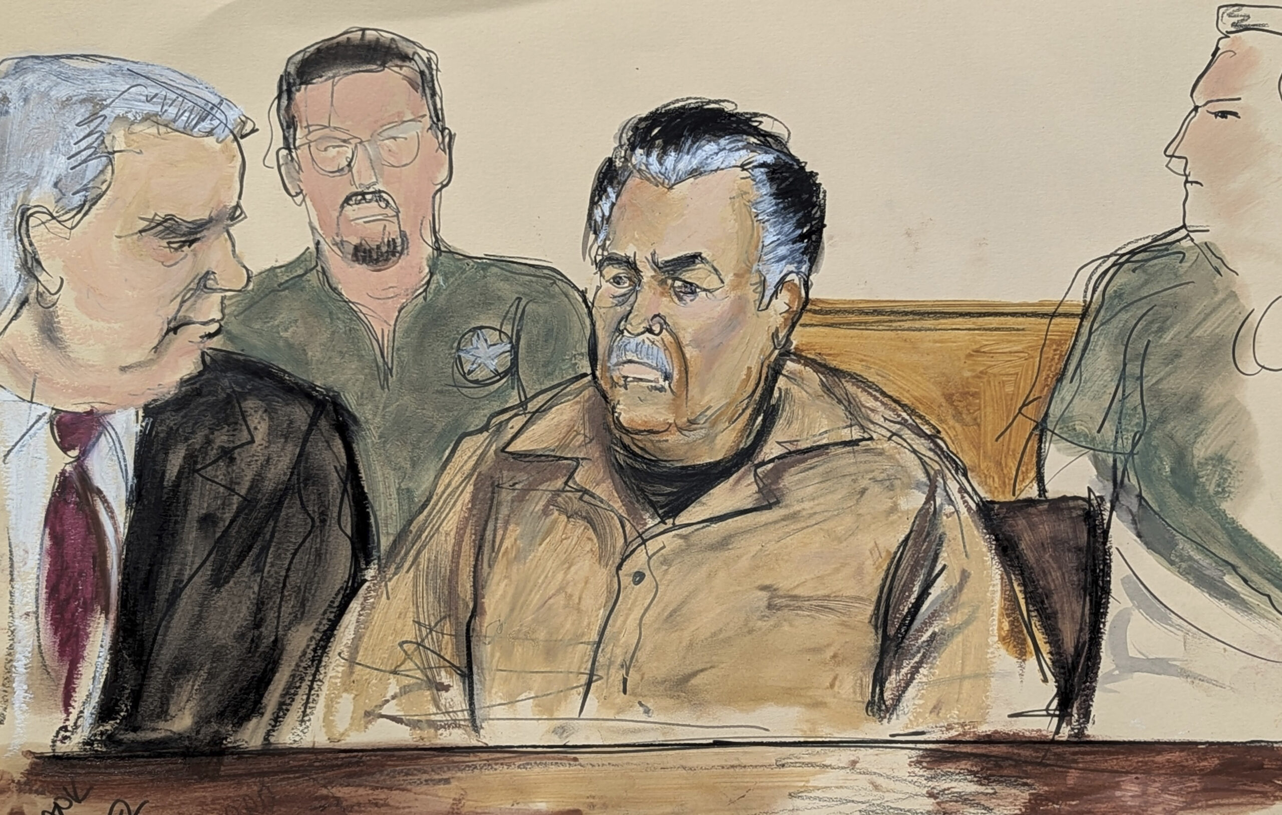 FILE - In this courtroom sketch, Ismael “El Mayo” Zambada, center, is seated beside his defense...