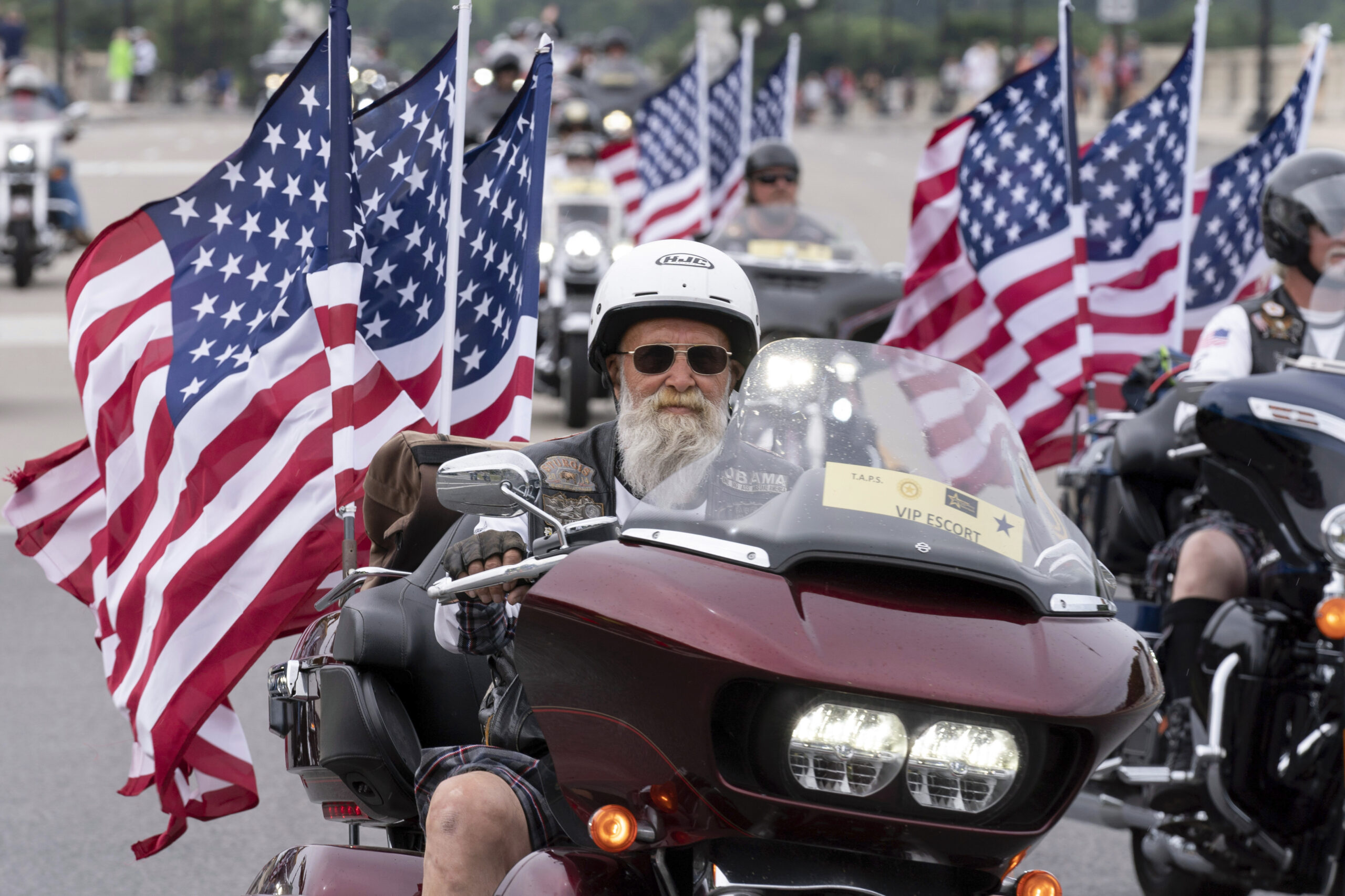 FILE - Participants in the "Rolling to Remember" motorcycle rally ride past Arlington Memorial Brid...