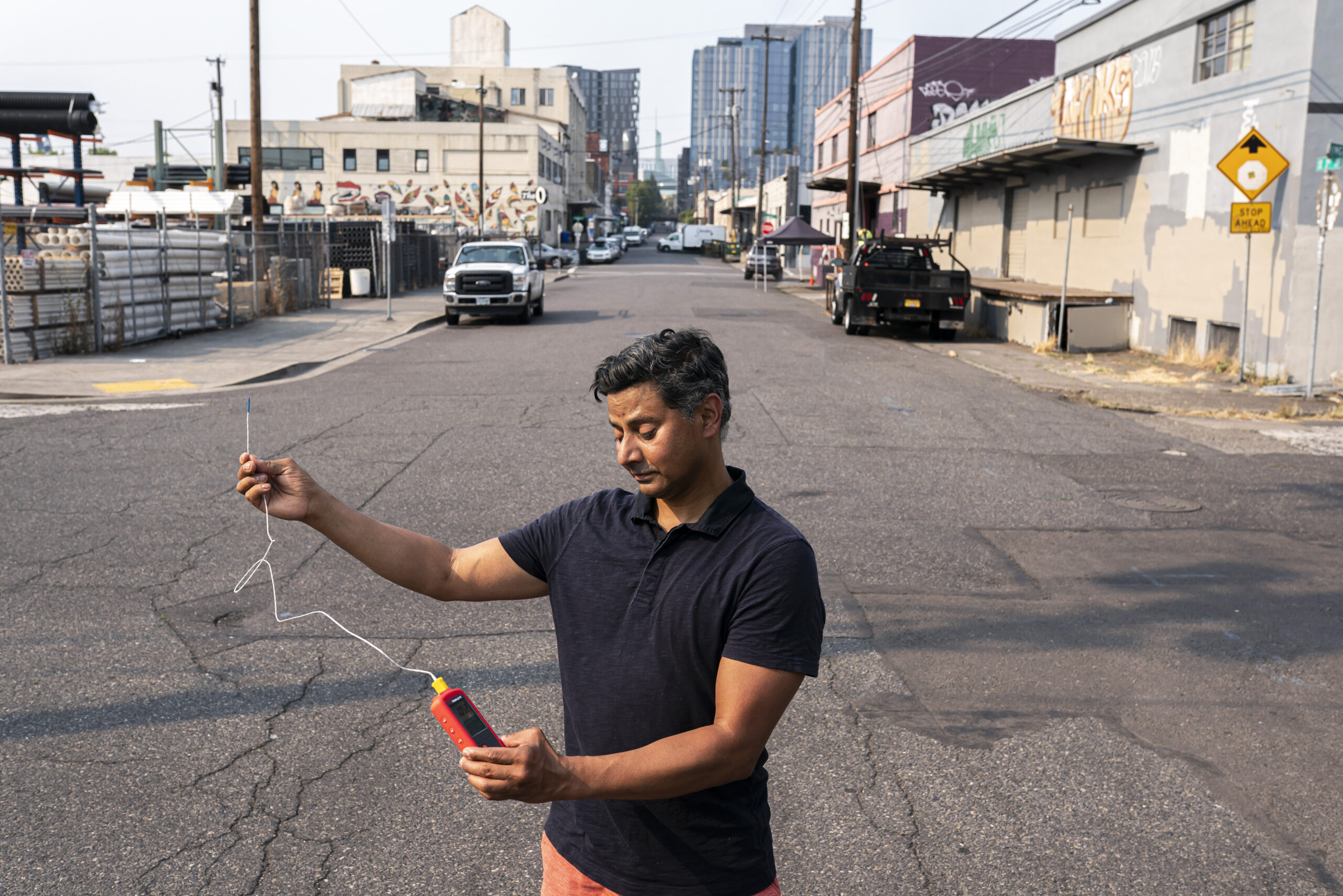 FILE - Vivek Shandas, a professor of climate adaptation at Portland State University, takes a tempe...