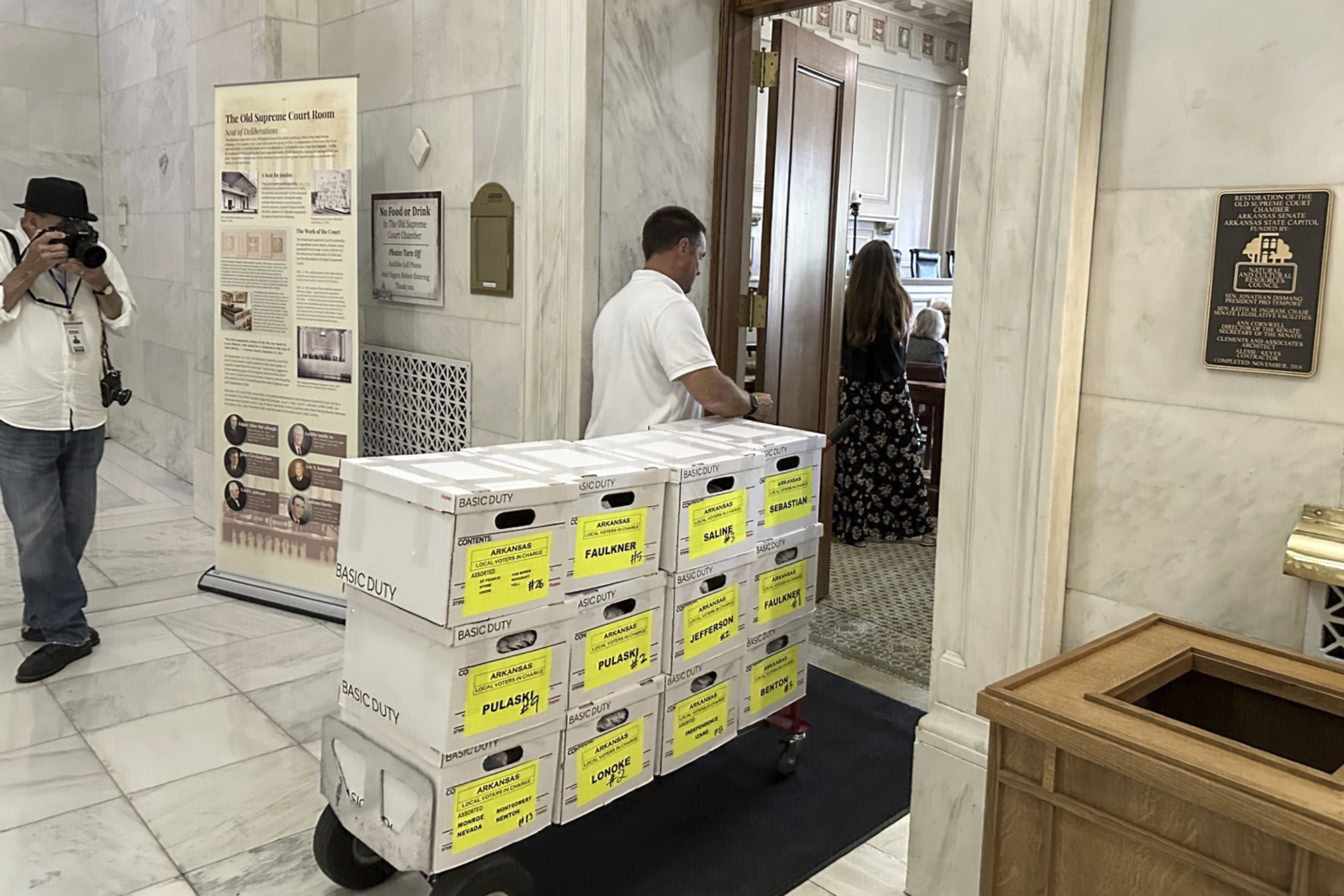 FILE - Boxes of petitions for proposal aimed at blocking a planned casino are delivered to the Capi...