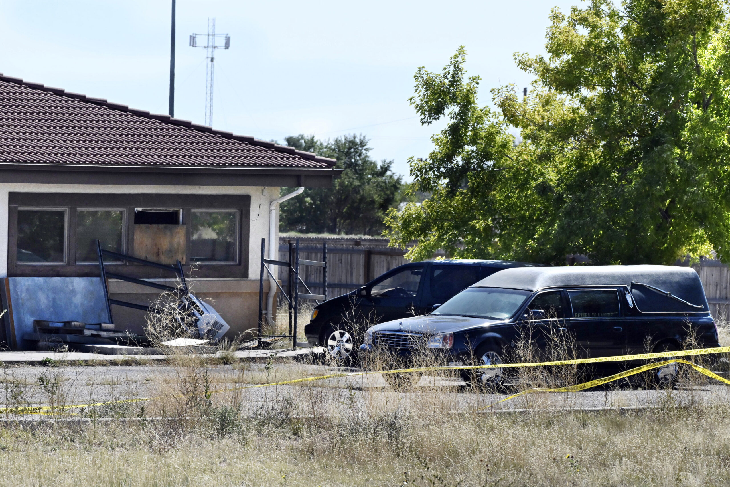 FILE - A hearse and debris can be seen at the rear of the Return to Nature Funeral Home, Oct. 5, 20...