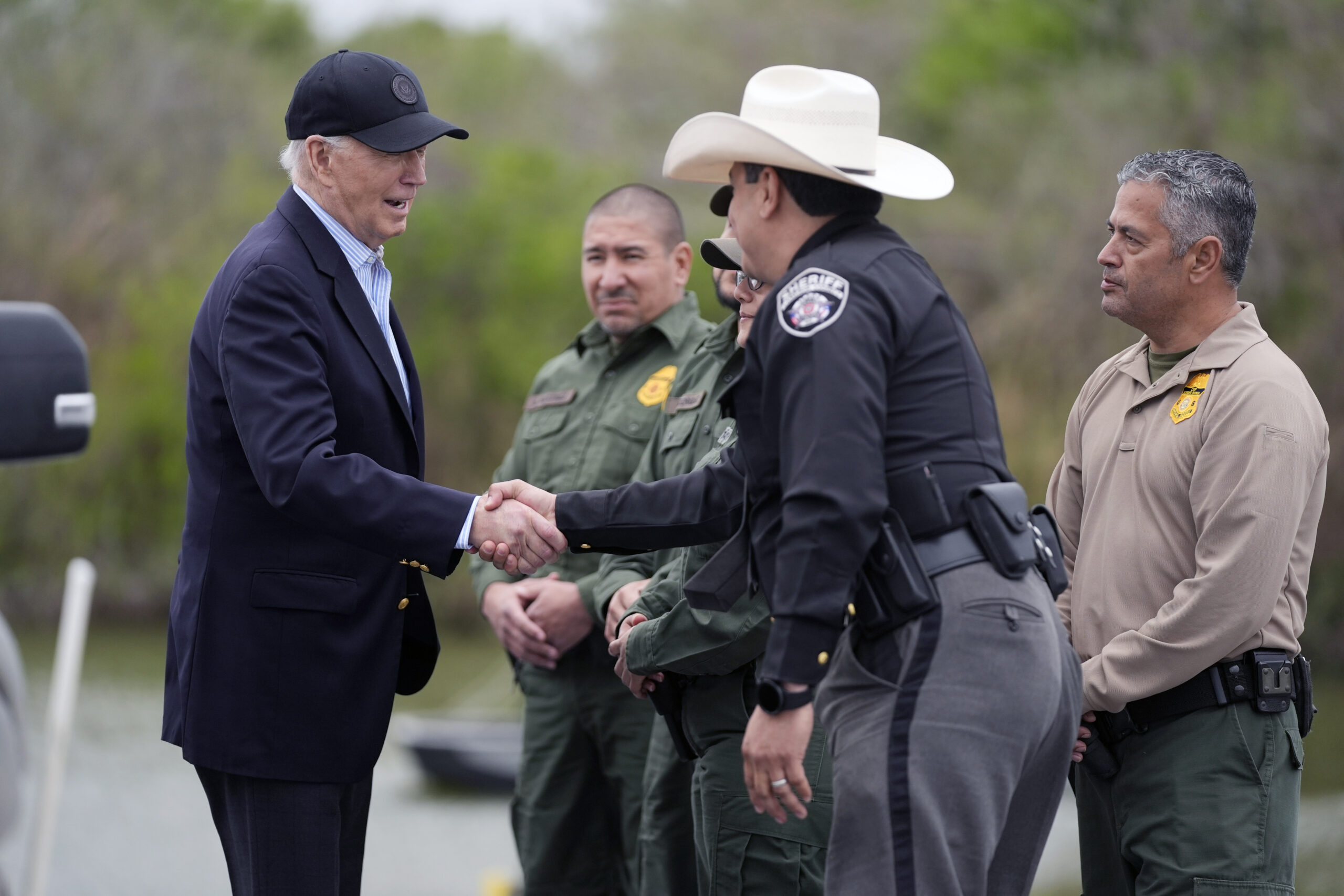 FILE - President Joe Biden talks with the U.S. Border Patrol and local officials, as he looks over ...