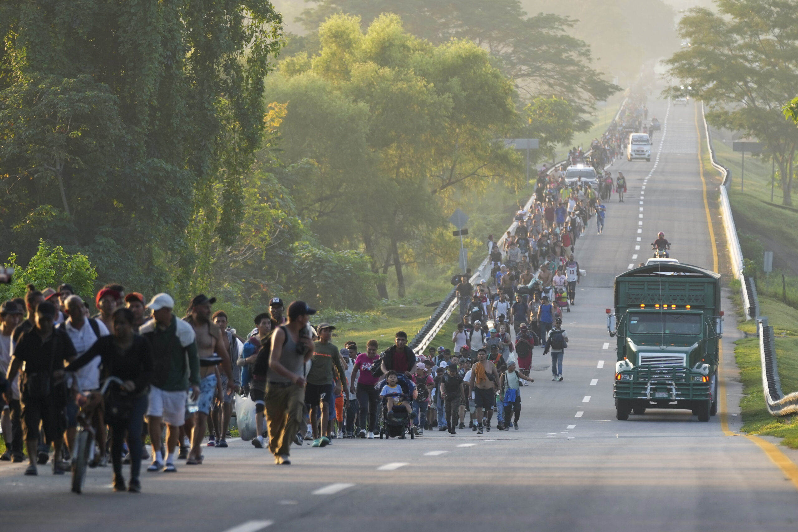 Migrants walk along the highway in Huixtla, southern Mexico, heading toward the country's northern ...