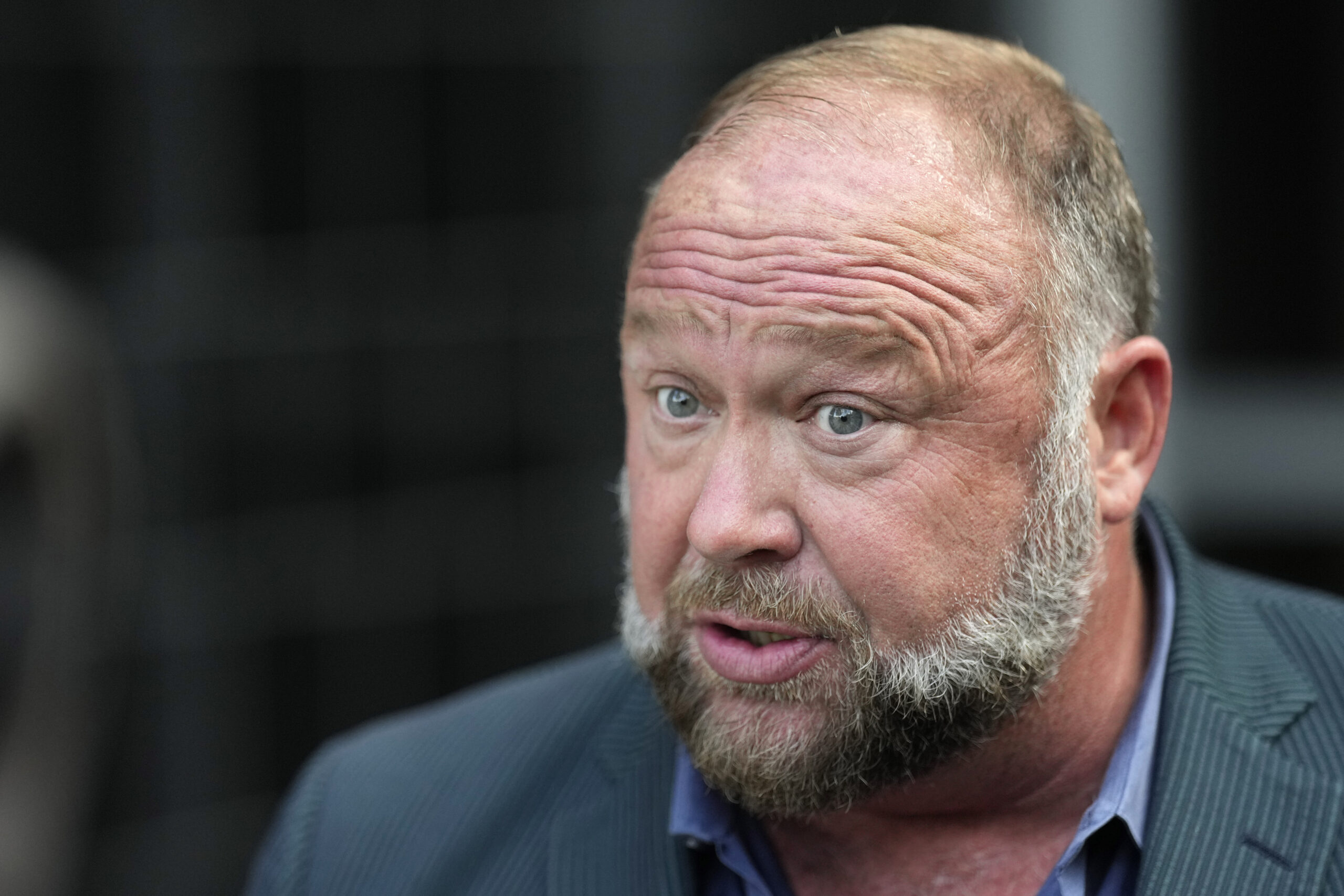 FILE - Right-wing conspiracy theorist Alex Jones speaks to the media after arriving at the federal ...