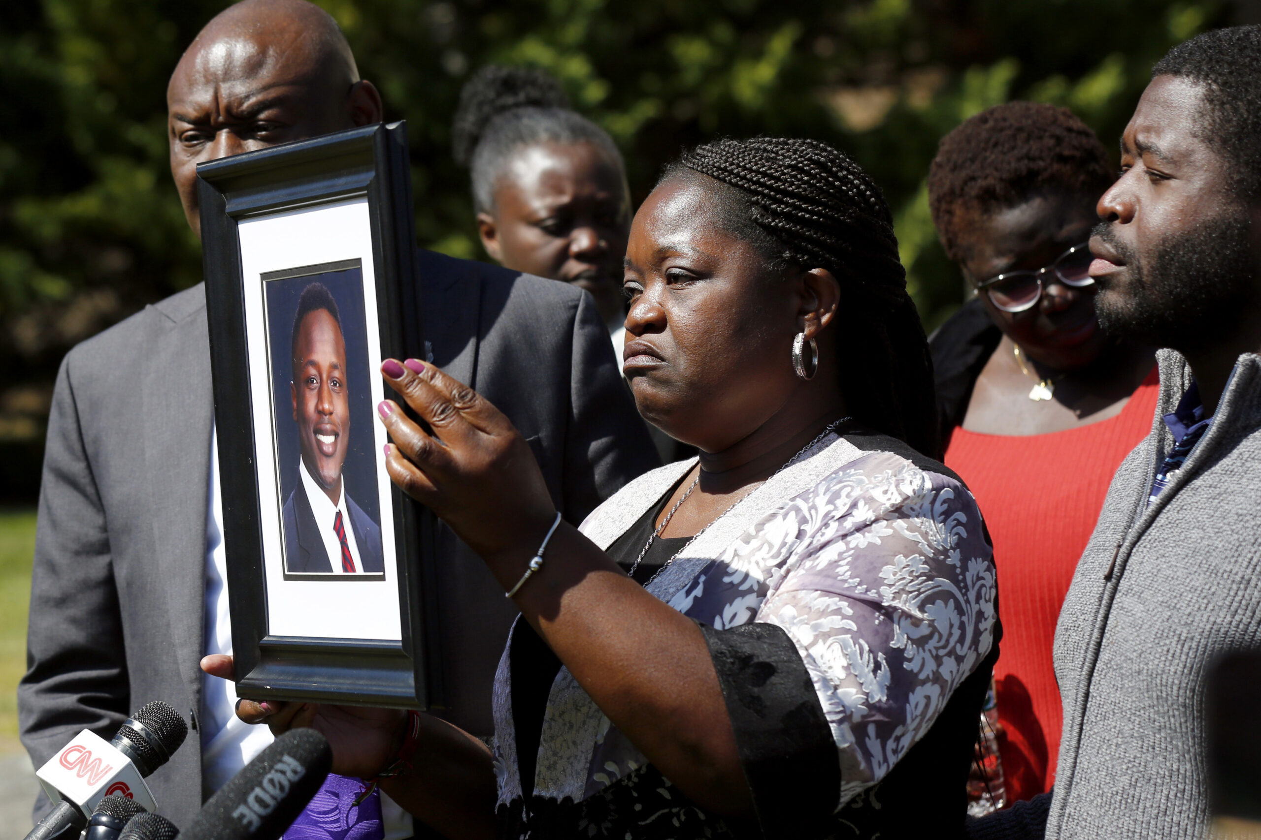 FILE - Caroline Ouko, mother of Irvo Otieno, holds a portrait of her son accompanied by attorney Be...