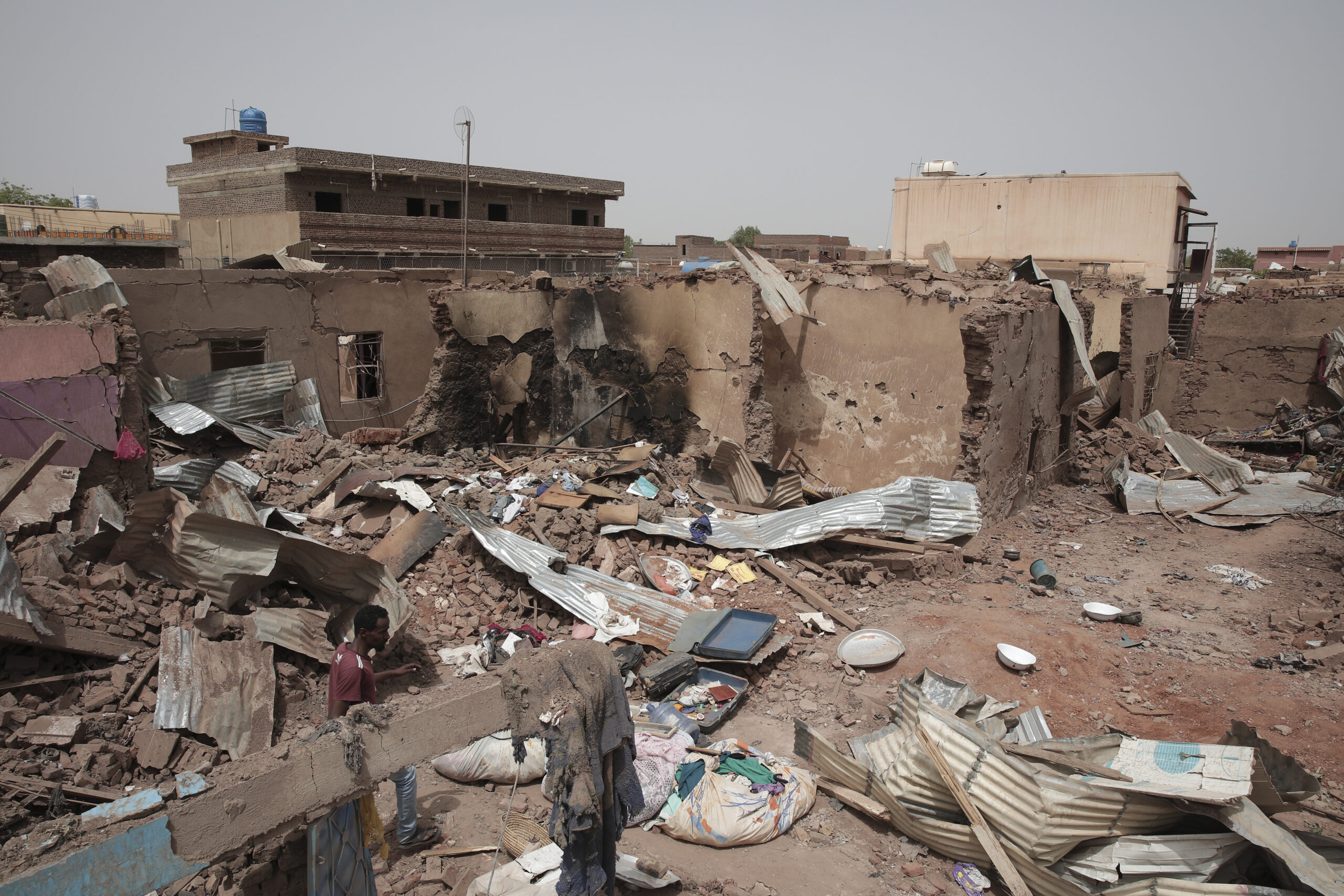 File - A man walks by a house hit in recent fighting in Khartoum, Sudan, an area torn by fighting b...