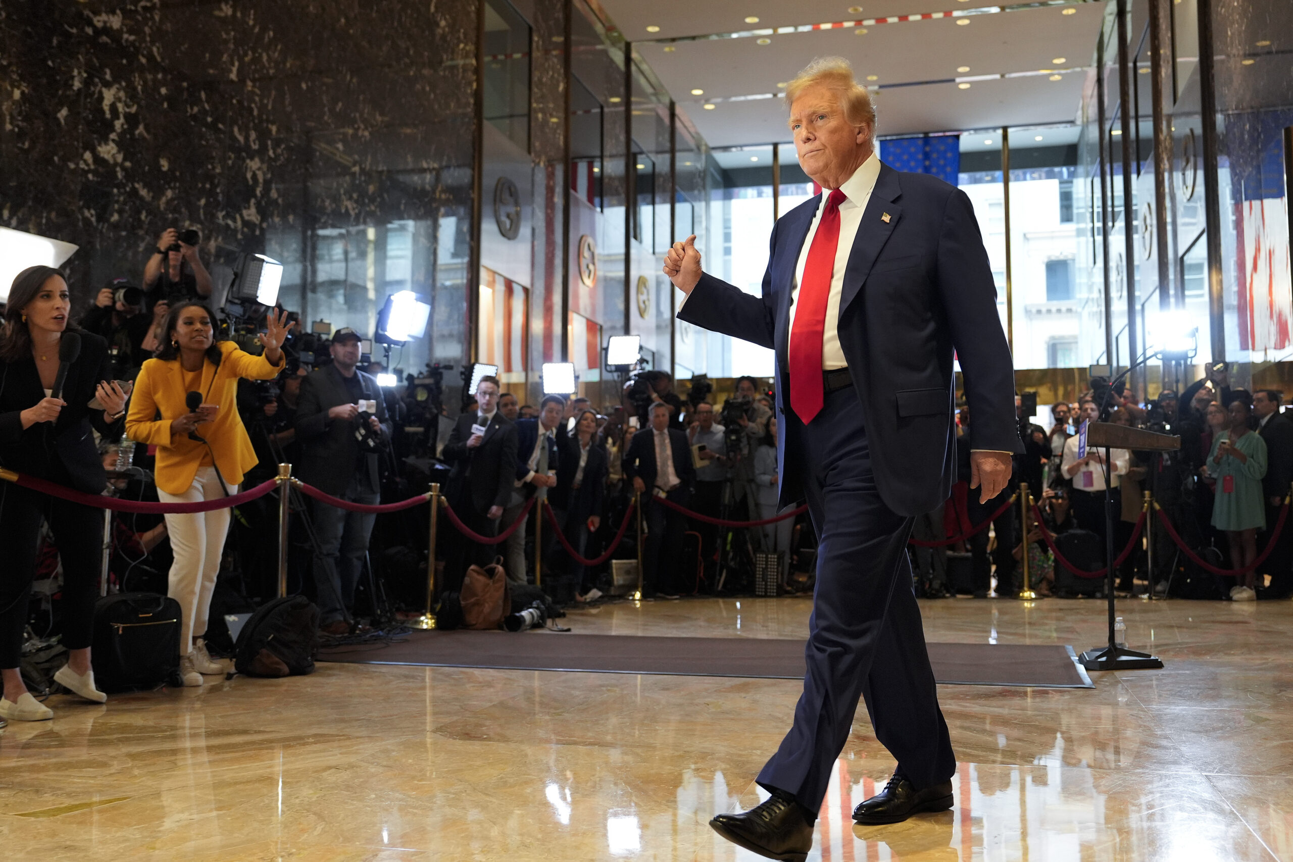 FILE - Former President Donald Trump gestures as he leaves after speaking at a news conference at T...