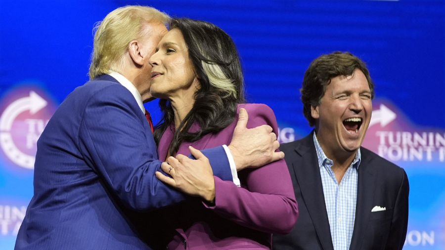 Photo: Former Democratic Rep. Tulsi Gabbard hugs Republican presidential nominee former President D...