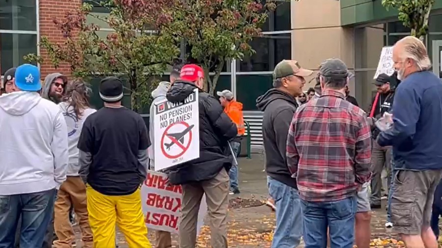 Machinist union members passed by a vocal "no" effort from fellow union members as they get to the ...