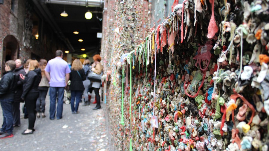 Image: Patrons walk down the alley at Pike Place Market where the Gum Wall is located....