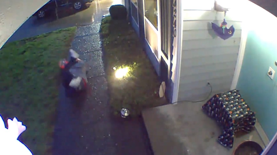 Image: A Halloween trick-or-treater was caught on surveillance video swiping an entire bowl of cand...