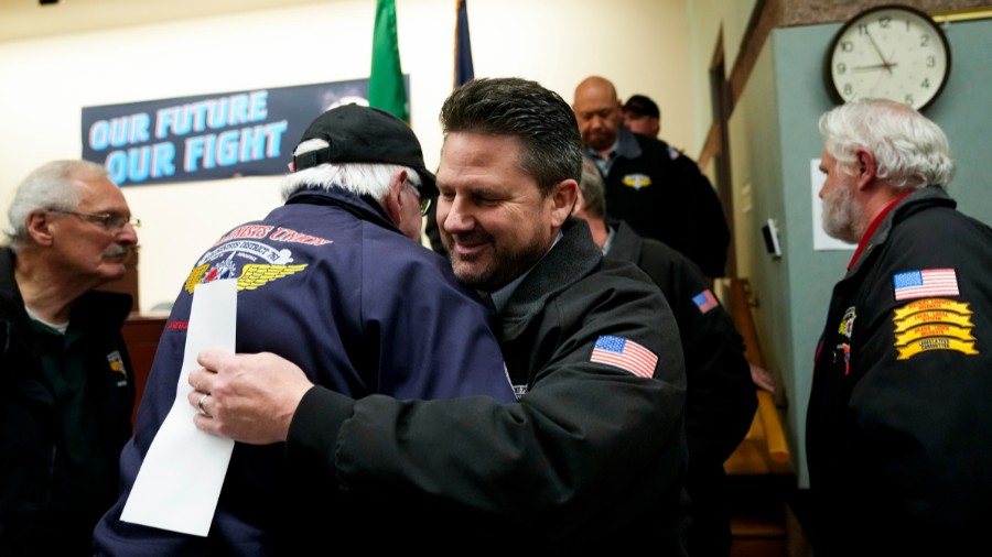 Image: IAM District 751 president Jon Holden greets union members after announcing they voted to ac...