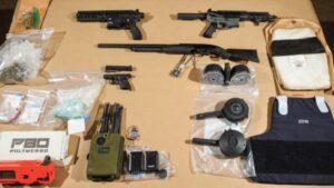 Photo: Investigators seized guns, drugs and a TSA badge, among other items, while executing a search warrant for men accused of drug trafficking.