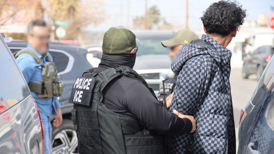 Photo: ICE agents make an arrest of an illegal immigrant during a multi-city operation. In Washingt...