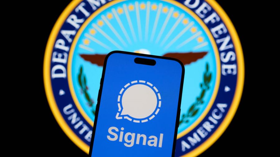 The Signal encrypted messaging application is seen on a mobile device with the Department of Defenc...