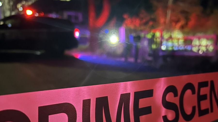 Crime scene tape at the site of a deadly confrontation in north Seattle, where police say a suspect...