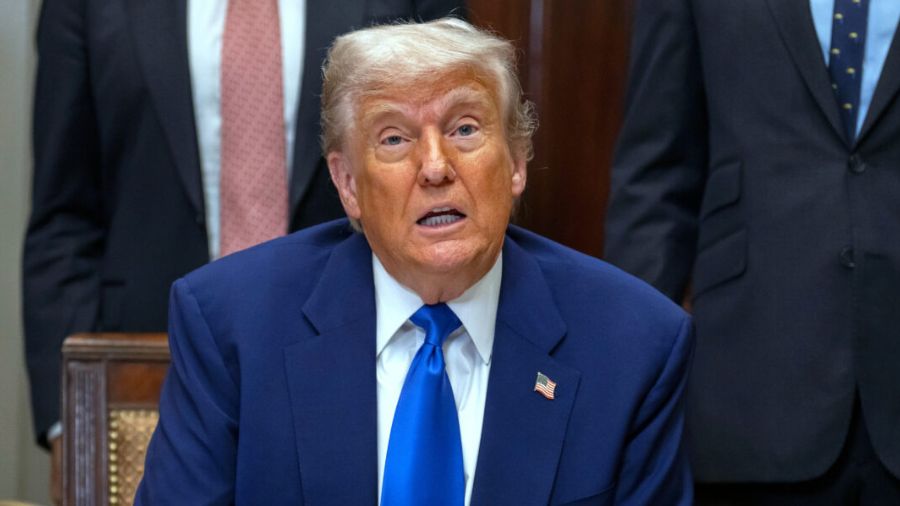 President Donald Trump answers a reporter's question during an event in the Roosevelt Room at the W...