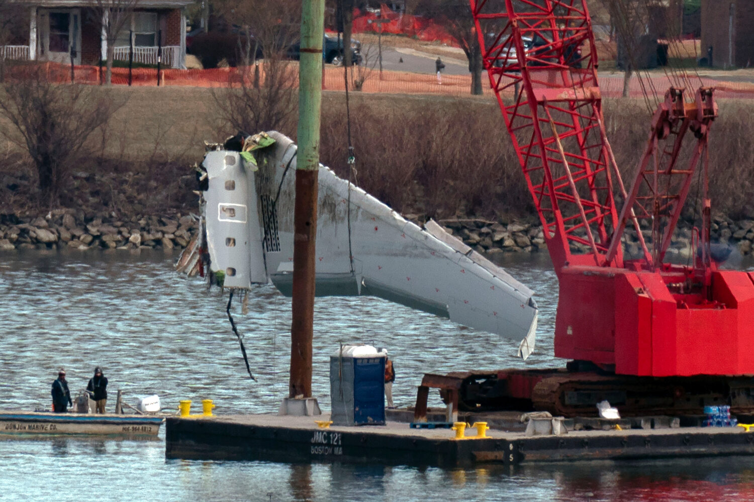 FILE - Rescue and salvage crews pull up airplane wreckage of an American Airlines jet in the Potoma...