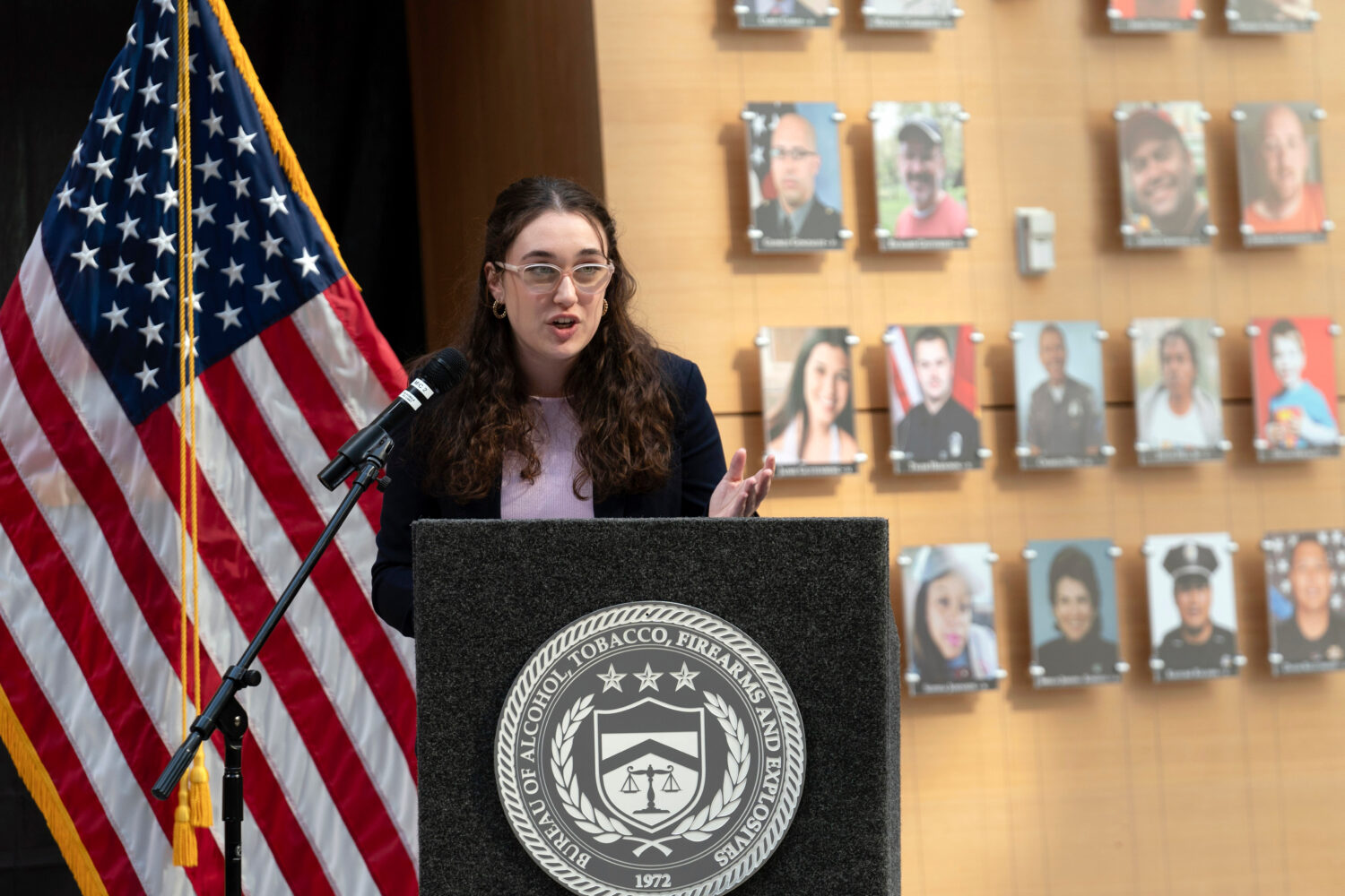 FILE - Survivor of gun violence Mia Tretta speaks while standing next to a wall with photographs of...