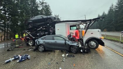 Unlicensed driver arrested after car carrier nearly flips on I-5, sending 3 to hospital