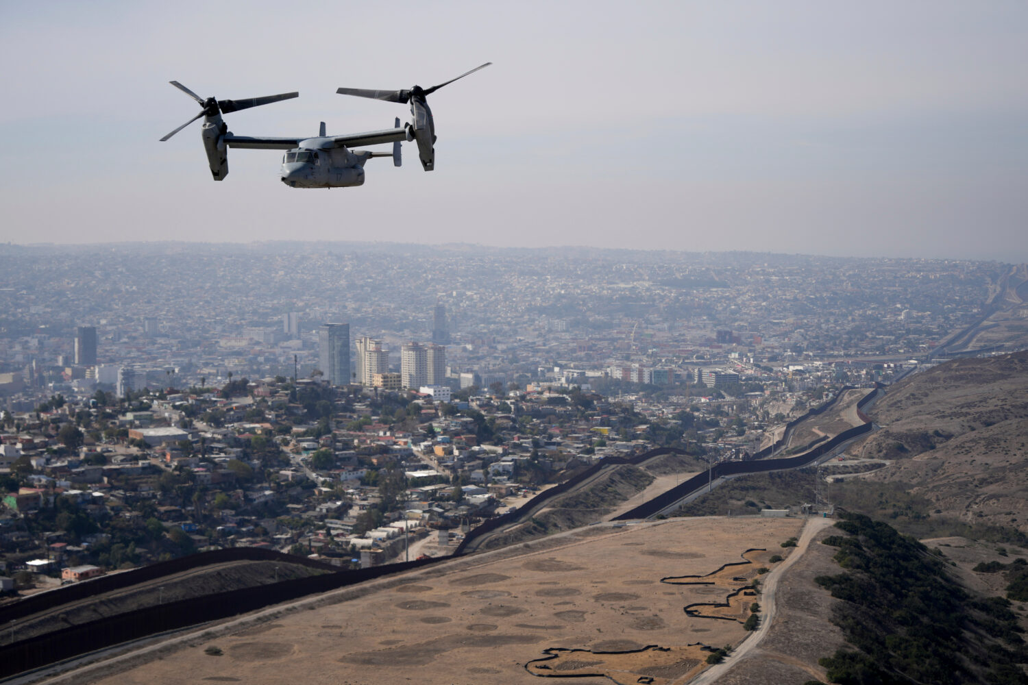 A U.S. Marine Osprey is flown over the border, Jan. 31, 2025, near San Diego. (AP Photo/Jae C. Hong...