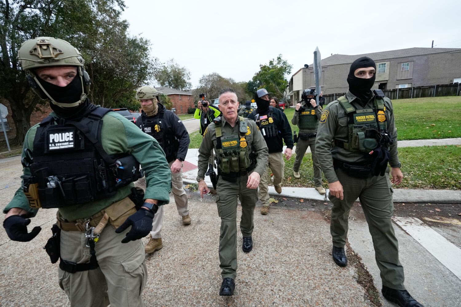 FILE - Customs and Border Patrol commander Gregory Bovino walks with border patrol agents through a...