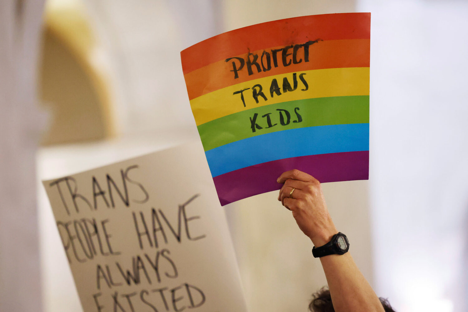 FILE - Protestors hold signs during a rally at the state capitol in Charleston, W.Va., on March 9, ...