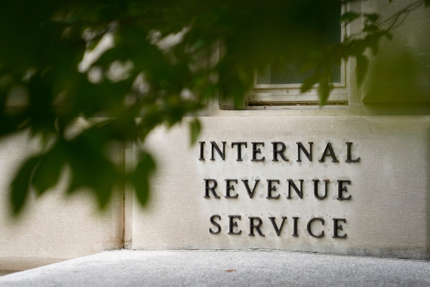 FILE - A sign is displayed outside the Internal Revenue Service building May 4, 2021, in Washington...