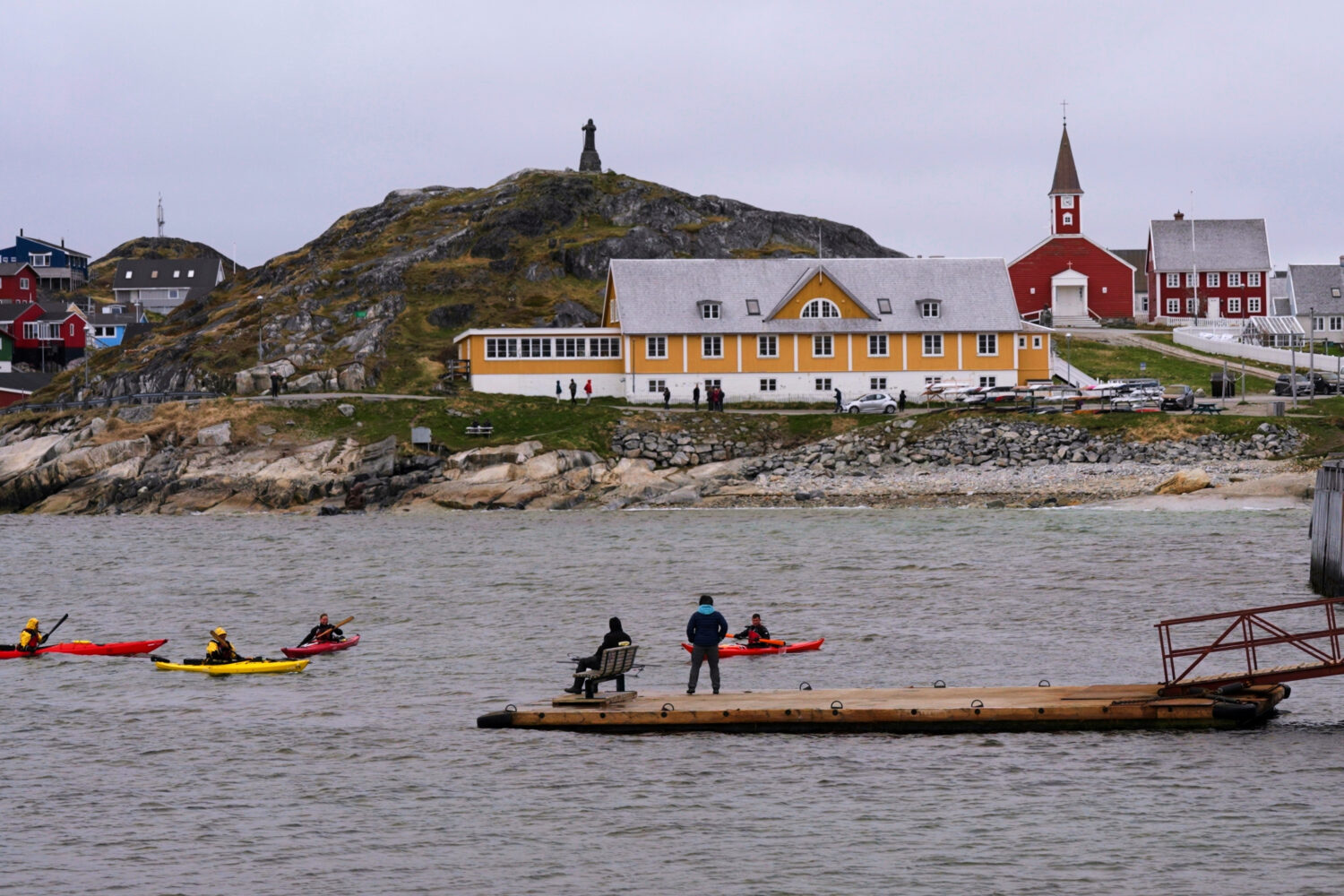FILE - Tourists kayak at sea in front of Nuuk Cathedral in Nuuk, Greenland, June 16, 2025. (AP Phot...