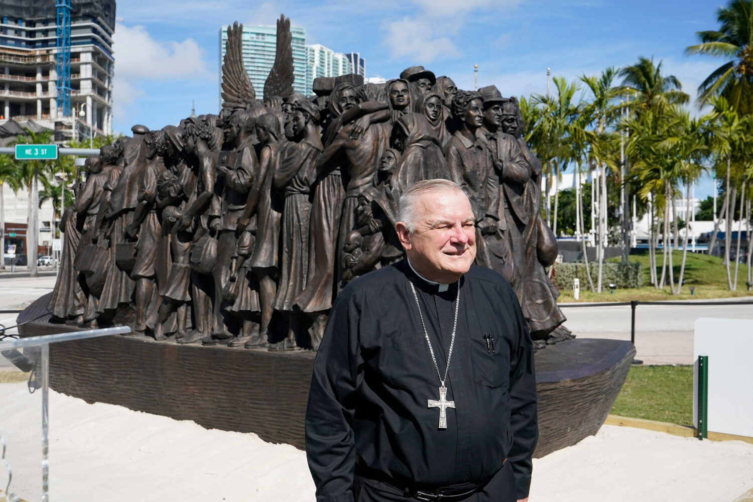 FILE - Archbishop of Miami Thomas Wenski poses in front of a traveling bronze sculpture titled "Ang...