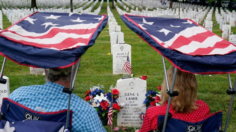 Eugene and Linda Lamie, of Homerville, Ga., sit by the grave of their son U.S. Army Sgt. Gene Lamie...