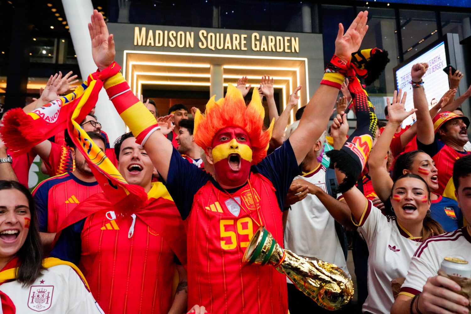 Spain fans gather for a rally on the eve of the World Cup final soccer match in New York's Times Sq...