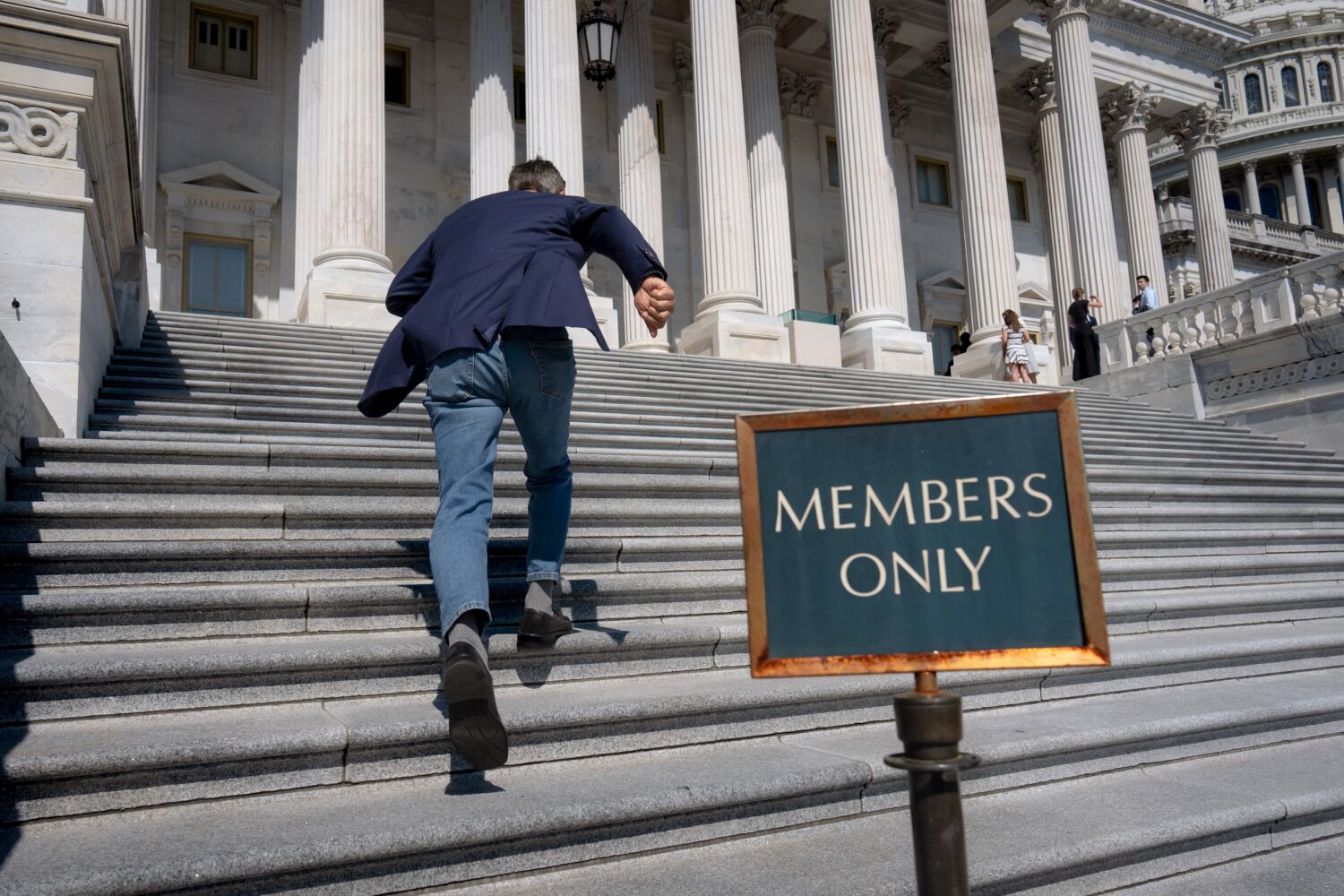 Rep. Darrell Issa, R-Calif., rushes up the steps at the Capitol for final votes before the House of...