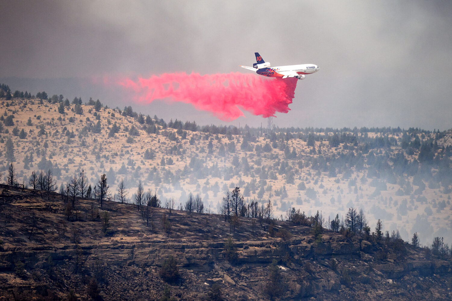 An air tanker drops retardant while battling the Bench fire on Saturday, July 25, 2026, in Jefferso...