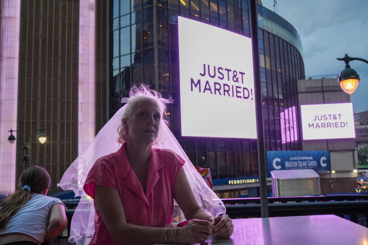 A Taylor Swift fan wearing a wedding veil sits at a restaurant next to Madison Square Garden where ...