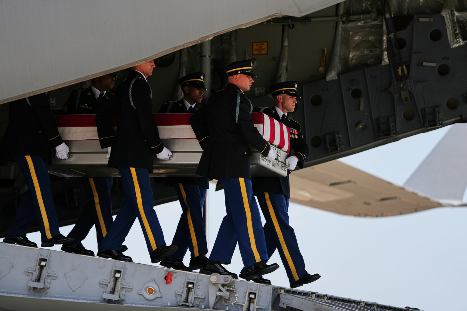 A U.S. Army carry team moves a transfer case containing the remains of 1st Lt. Tyler James Feehan o...