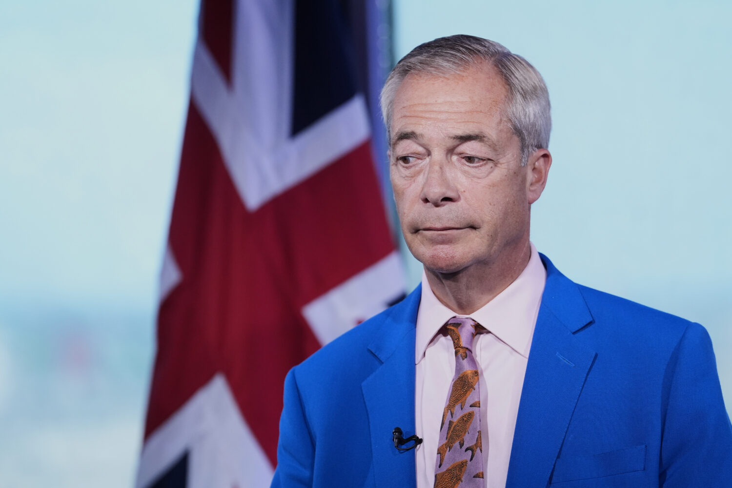 Reform UK leader Nigel Farage looks on as he makes a statement to the media at the party headquarte...