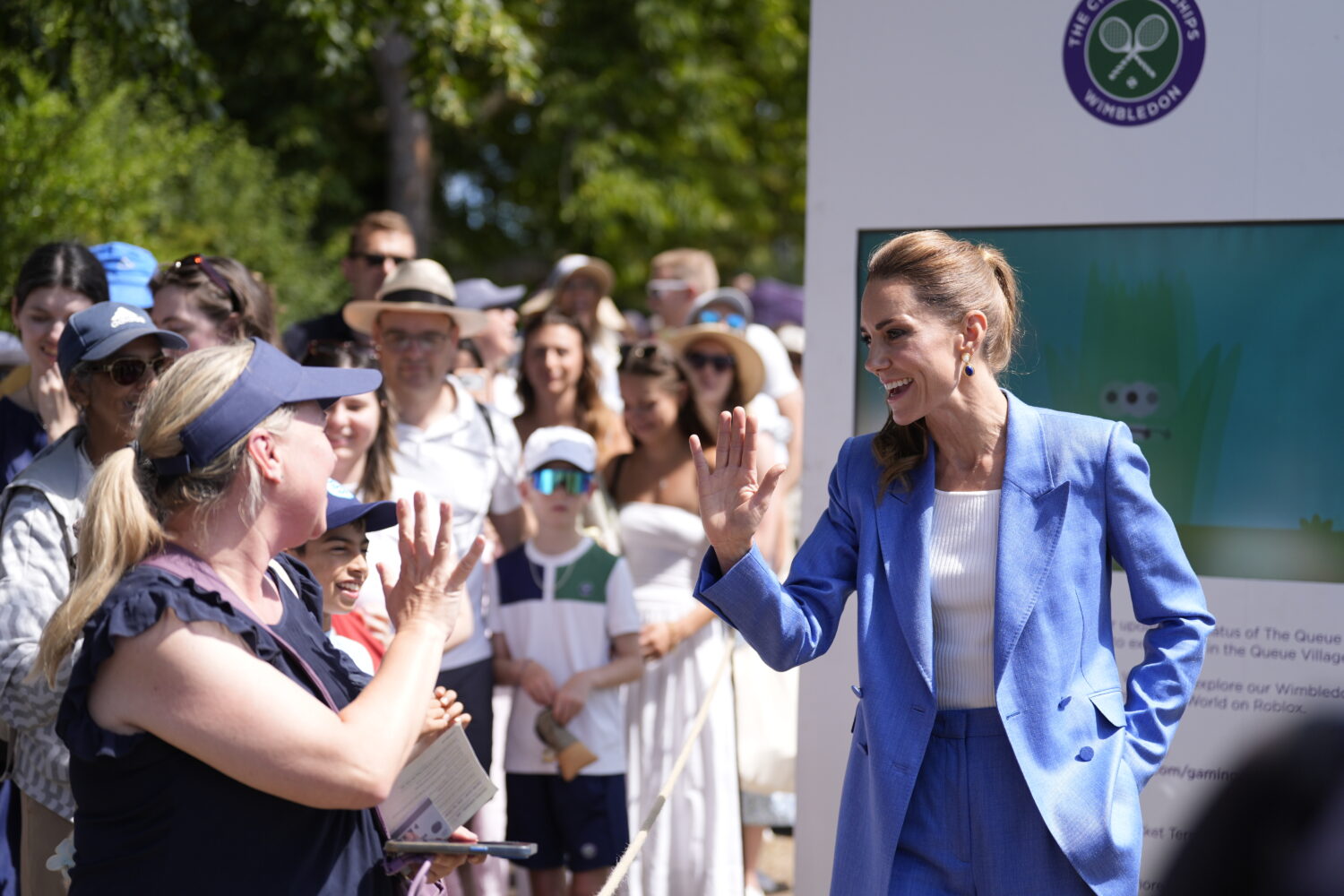 Britain's Kate, the Princess of Wales gestures during a visit on day four of the Wimbledon Tennis C...