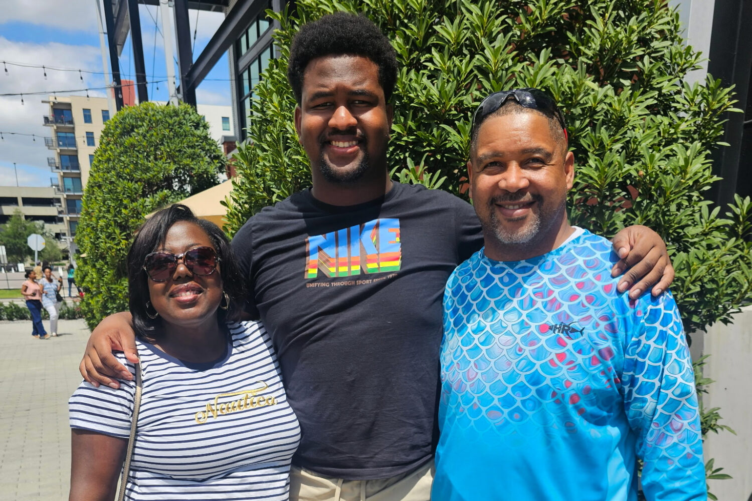 Calvin Dickey Jr., center, poses for a photo with his father, Calvin Dickey Sr., and mother, Nicole...