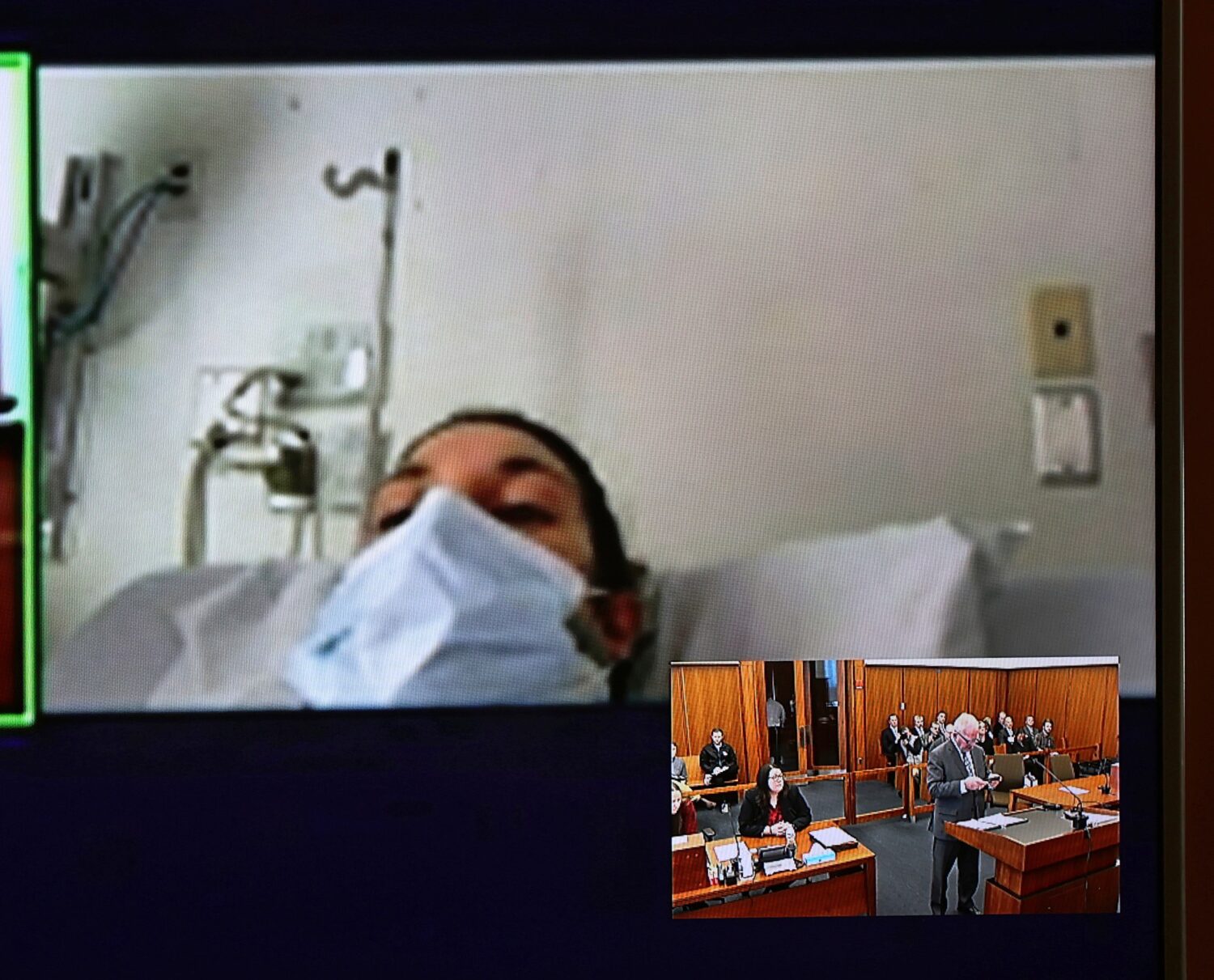 FILE - In this image from video, Lindsay Clancy, with a surgical mask over her face, appears from t...