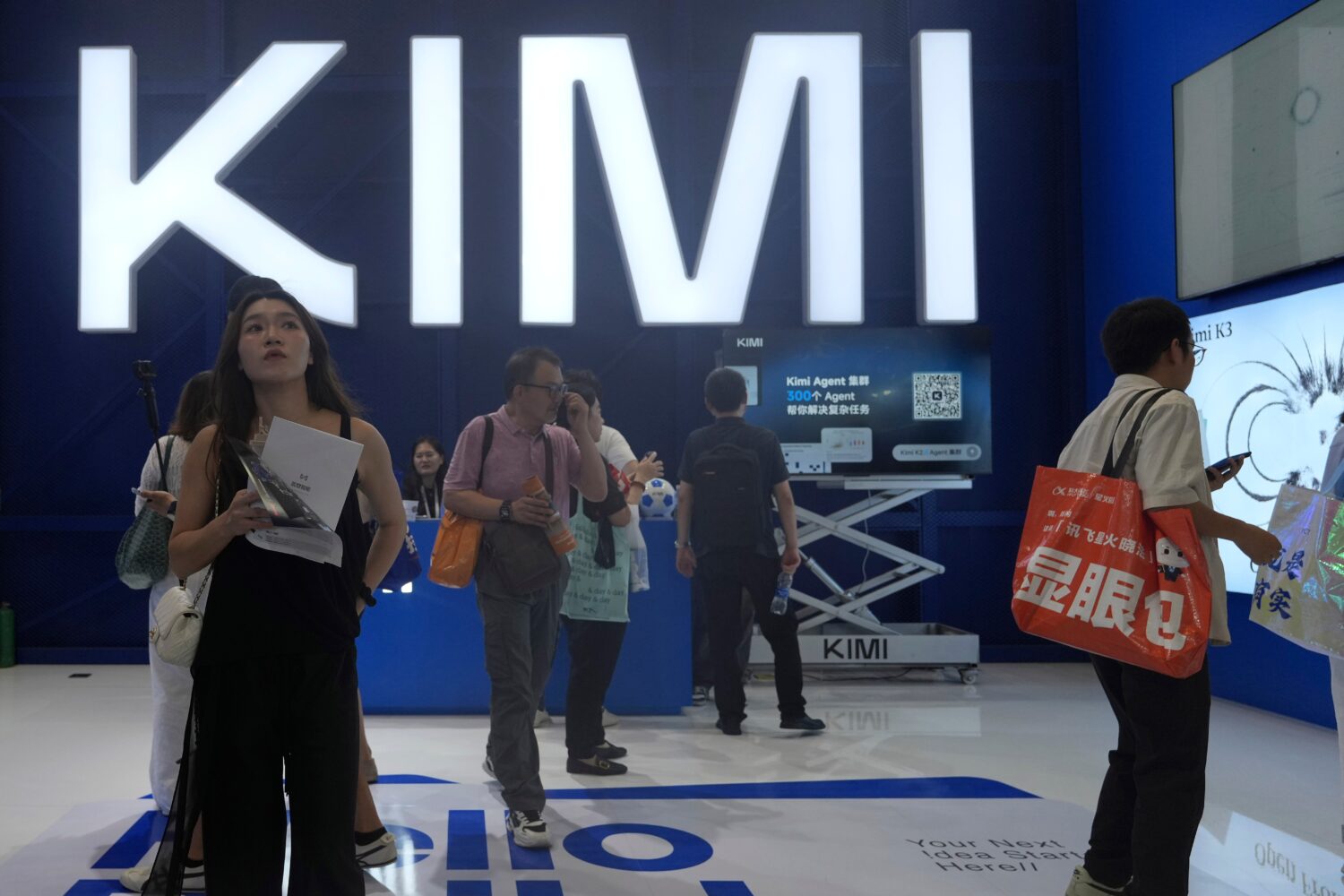 Visitors at the booth for Chinese AI Startup Moonshot's Kimi K3 during the World AI Conference in S...