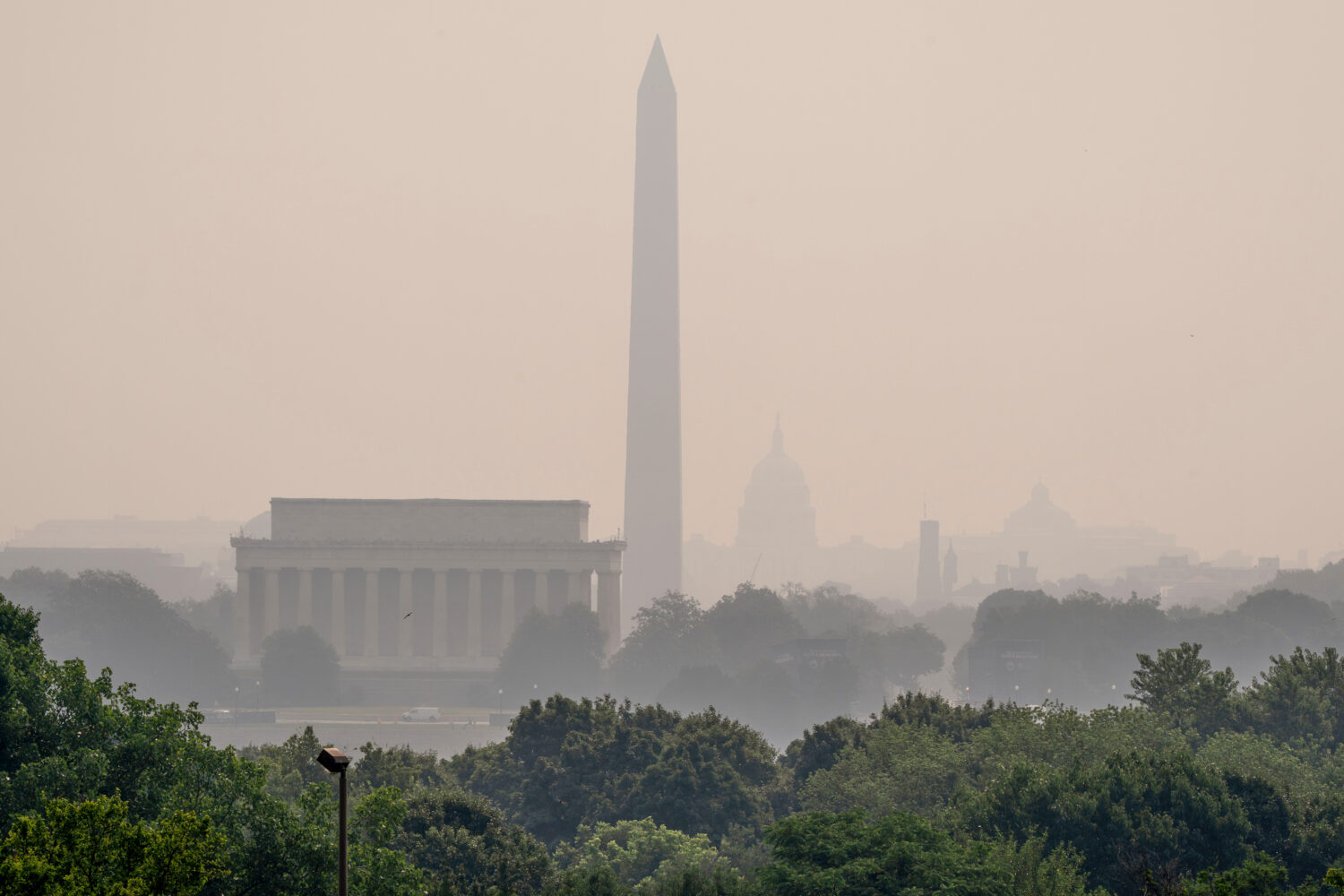 The Lincoln Memorial, the Washington Monument, and the U.S. Capitol, are barely visible from an ove...