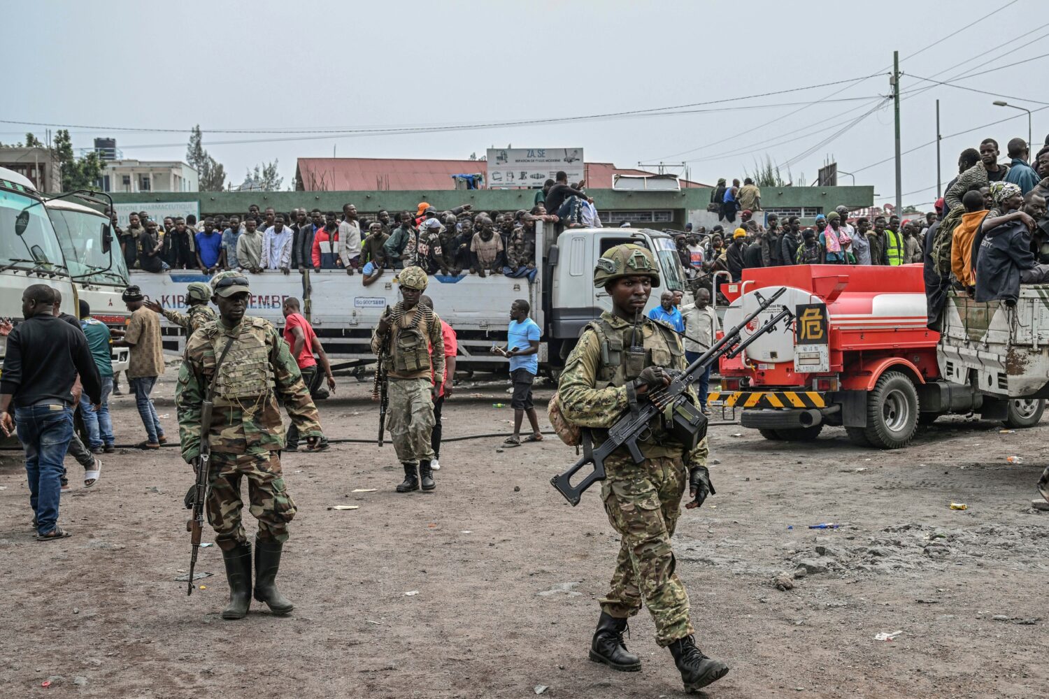 FILE - M23 rebels escort government soldiers and police who surrendered to an undisclosed location ...