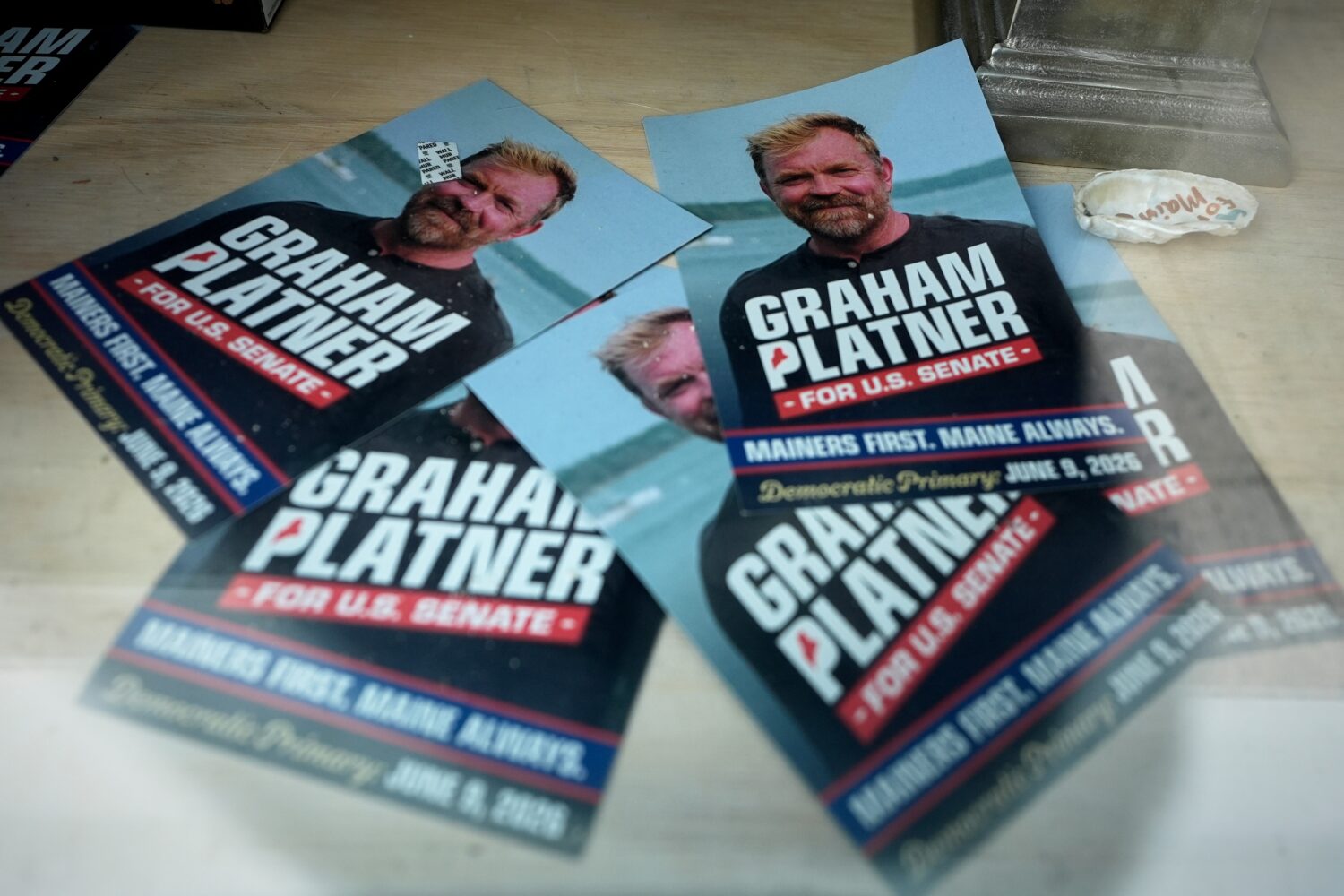 Campaign flyers for former Democratic candidate for U.S. Senate Graham Platner are seen at his head...