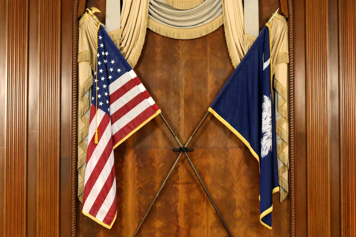 FILE - The U.S. and South Carolina flags hang in the South Carolina statehouse, March 16, 2021, in ...