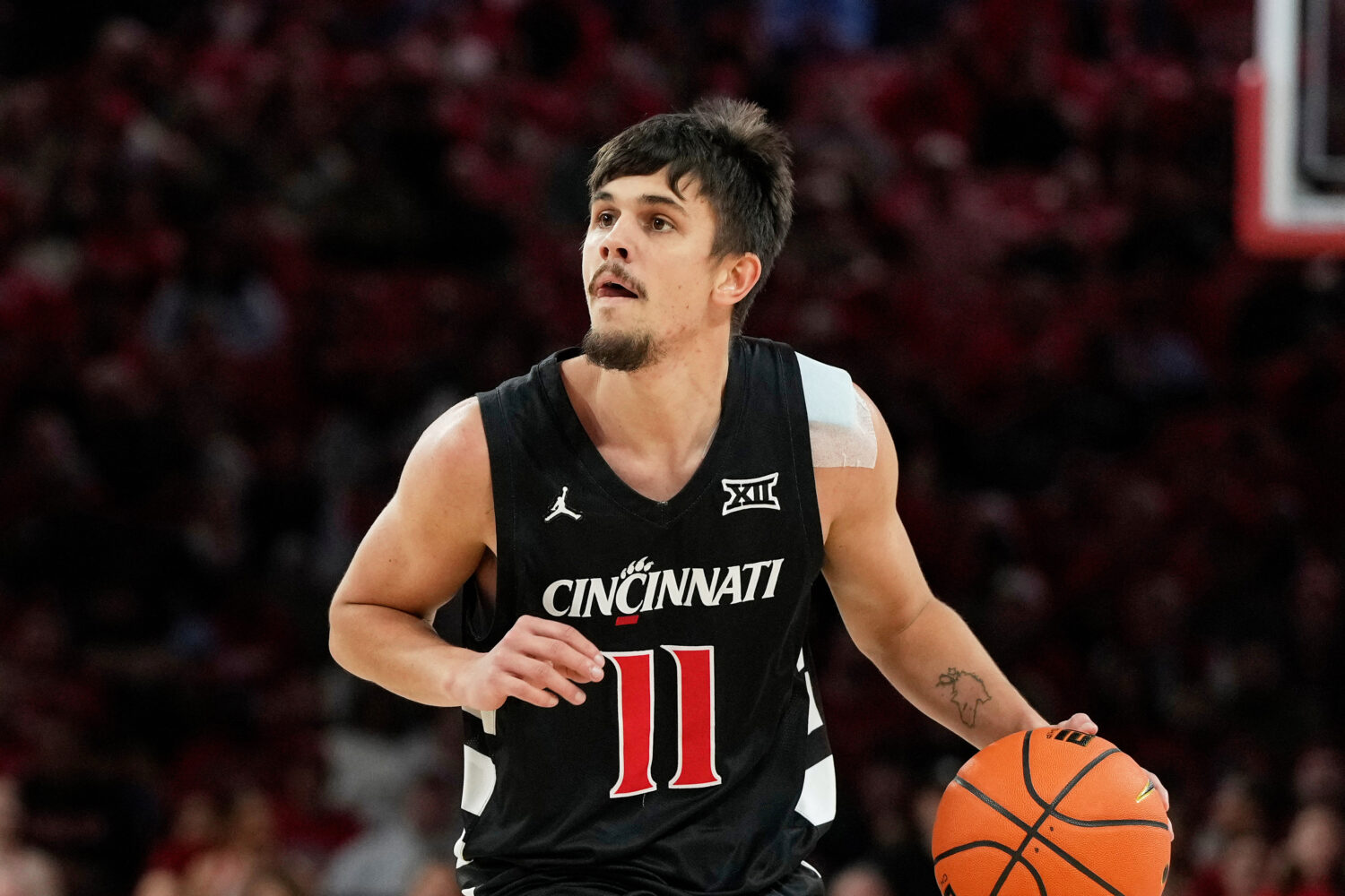FILE - Cincinnati guard Kerr Kriisa (11) handles the ball during the first half of an NCAA college ...