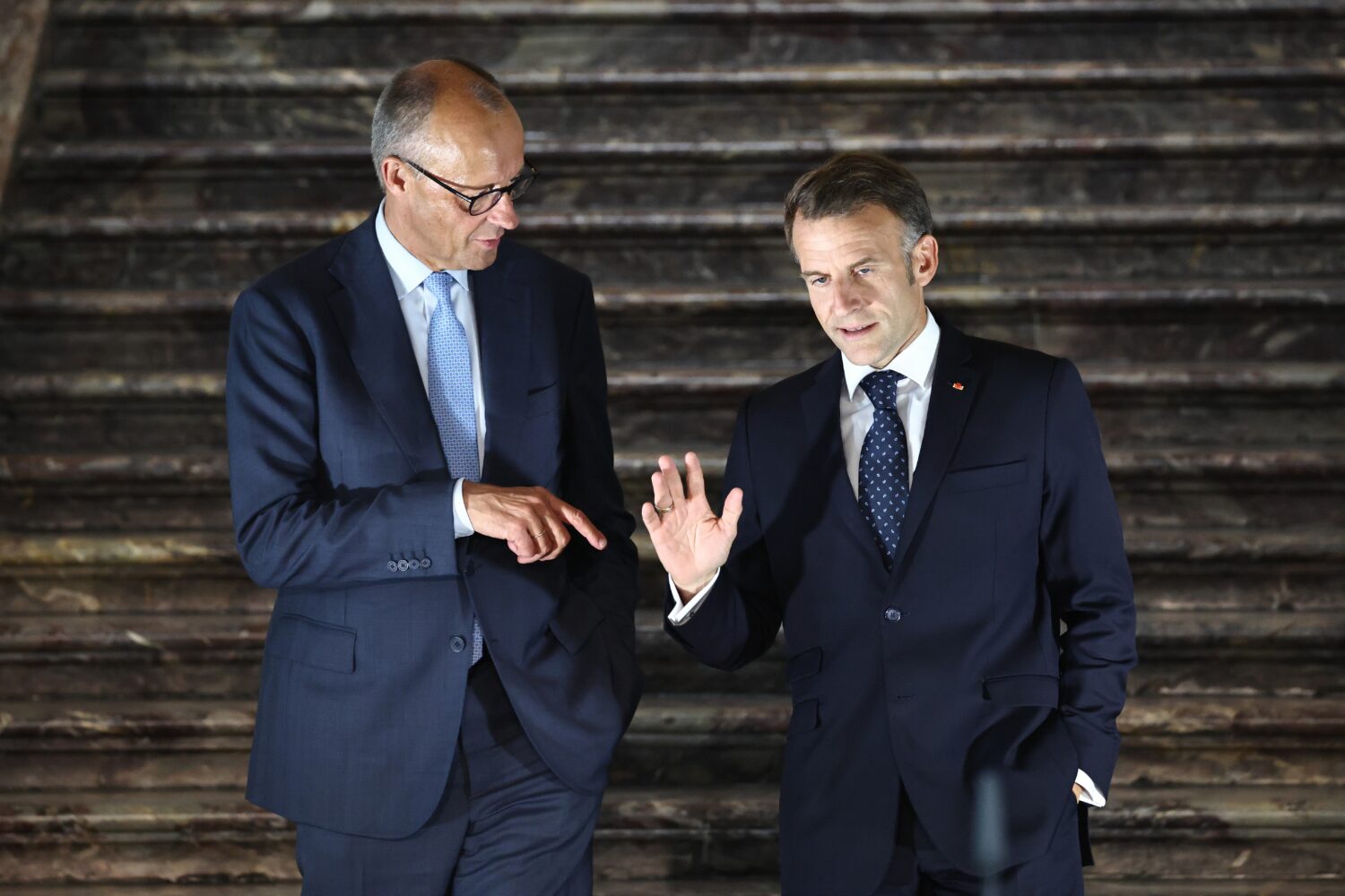 German Chancellor Friedrich Merz, left, talks with French President Emmanuel Macron as they arrive ...