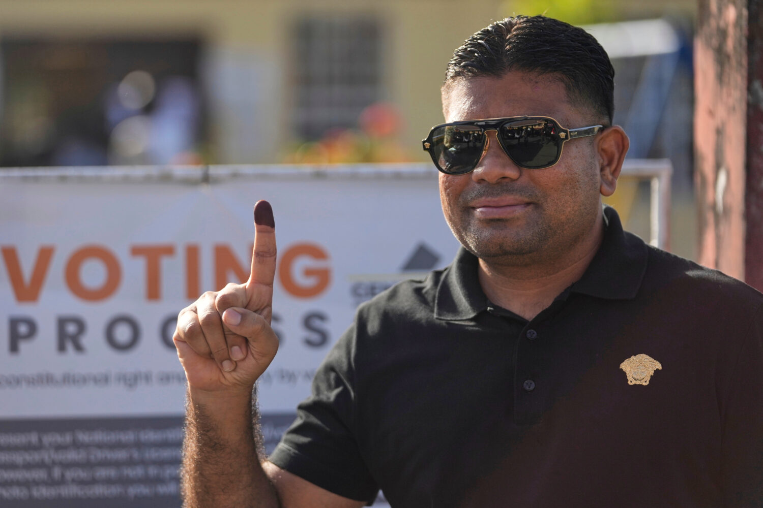 FILE - Presidential candidate Azruddin Mohamed, of the We Invest in Nationhood party, displays his ...