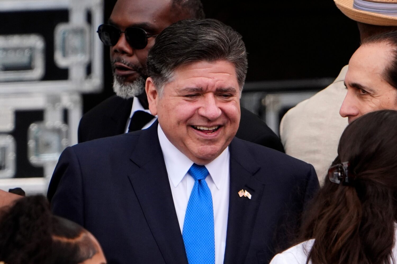 FILE - Illinois Gov. JB Pritzker, center, mingles ahead of the Obama Presidential Center dedication...