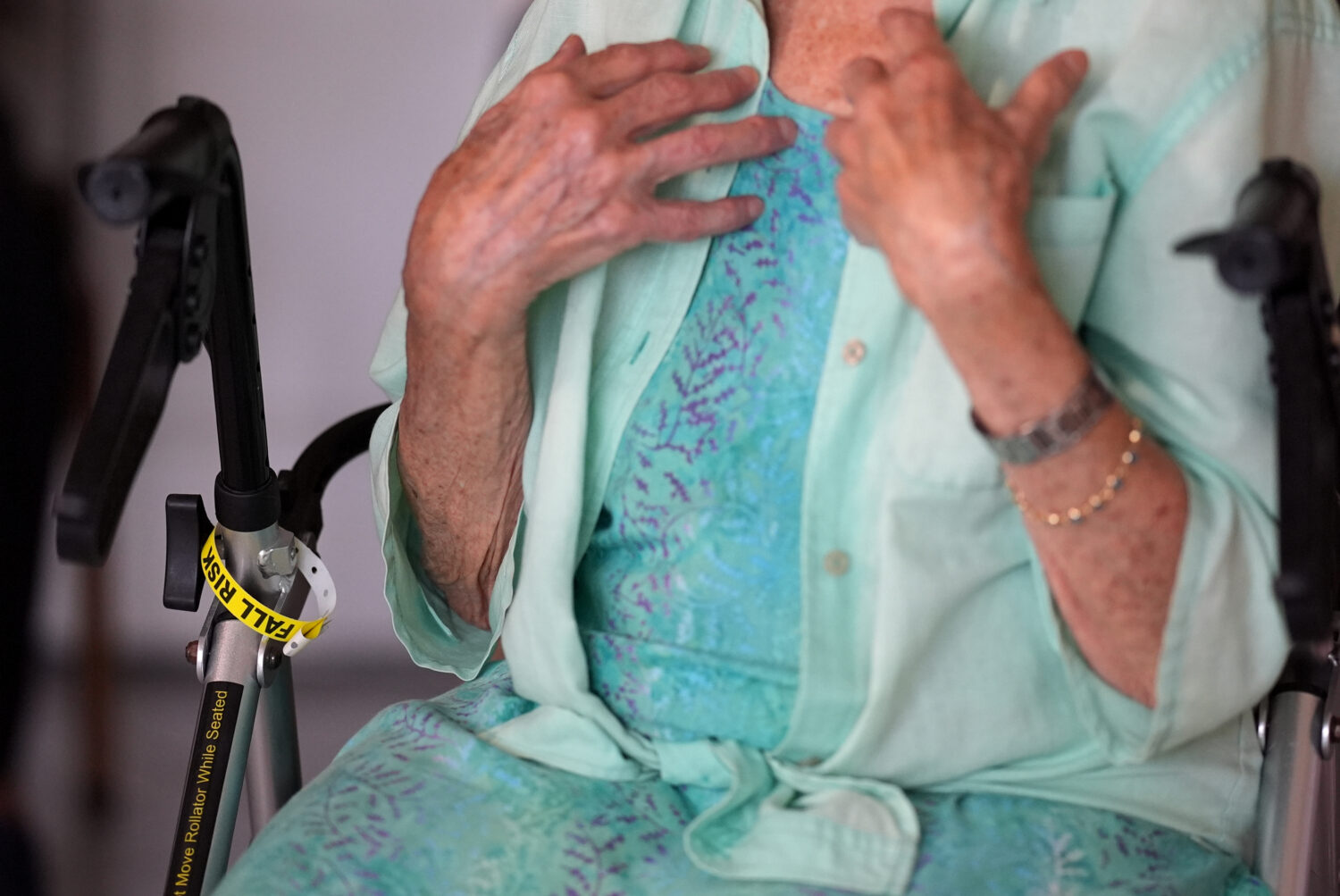 A "Fall Risk" alert bracelet marks the walker of Anna Fischbein as she speaks about the loss of a b...